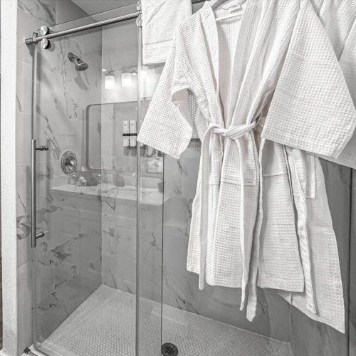 With luxury walk-in shower. White robes included.