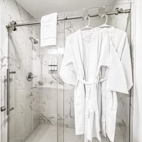 With luxury walk-in shower. White robes included.