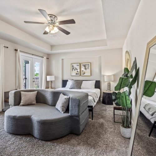 Primary bedroom with a king size bed and a full-size sleeper sofa!