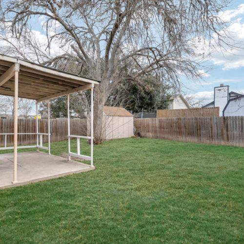 Huge backyard with covered patio.