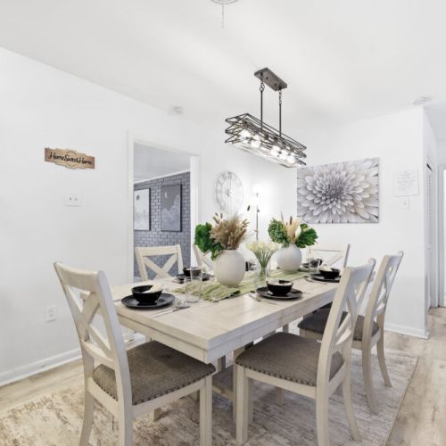 Spacious dining table that sits 6 with full tableware and silverware included.