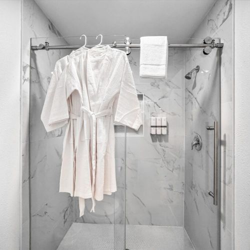 With luxury walk-in shower. White robes included.