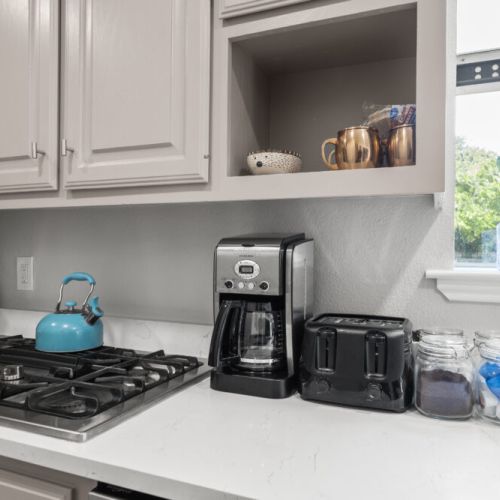 Cuisinart coffee maker with complimentary coffee, tea, sugar, and cream