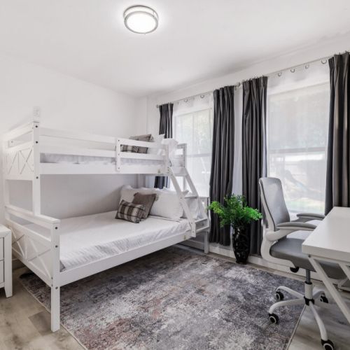 6th bedroom with 1 full size bed and 1 twin size bed (bunk bed). Plus, we include a workspace in this bedroom.