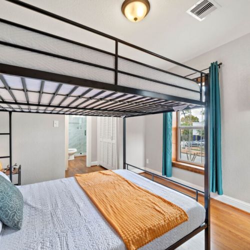 3rd bedroom with 2 queen size bunk beds. TVs included in all bedrooms.
