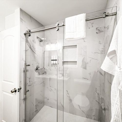 With luxury walk-in shower. White robes included.