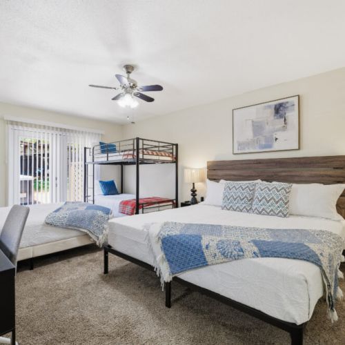 Primary bedroom with 1 king size bed, 1 queen bed, and 2 twin beds (bunk bed)