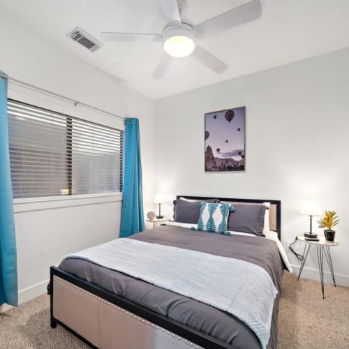 3rd bedroom with queen size bed and direct access to the back patio.