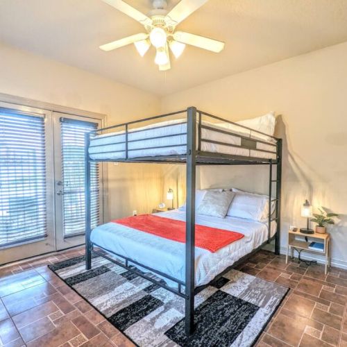 3rd bedroom with 2 queen size bunk beds and direct access to small patio.