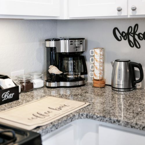 2-Way drip coffee machine with complimentary coffee, tea, sugar, and cream