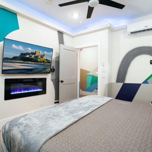 Relax in style with soft lighting, a touch of modern design, and the comfort of a warm fire