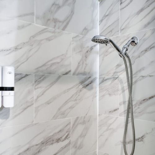 Step into comfort with this stylish shower with handheld shower head.