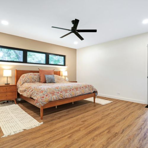 Primary bedroom with king size bed and direct access to backyard and pool.