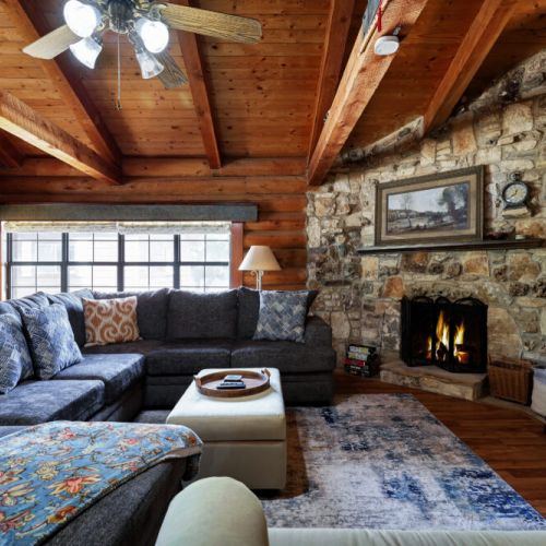 Curl up by the crackling fireplace, watch a movie, or play board games in this warm, inviting corner that feels straight out of a mountain retreat.