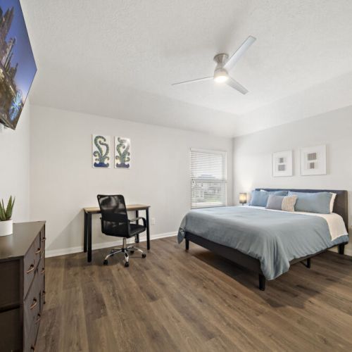 4th bedroom with a queen-size bed and a dedicated workspace.