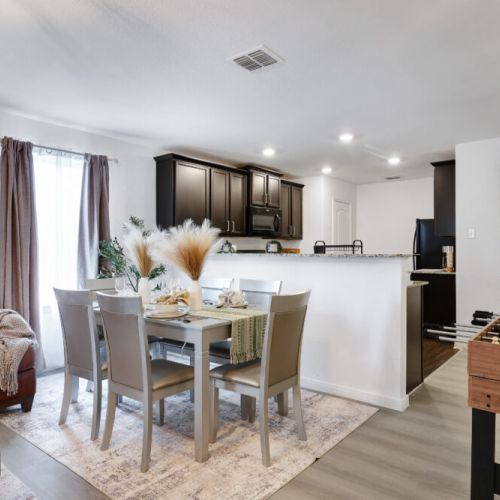Spacious dining table that sits 6 with full tableware and silverware included.