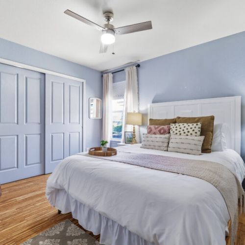 3rd bedroom with queen size bed and a comfy pouf
