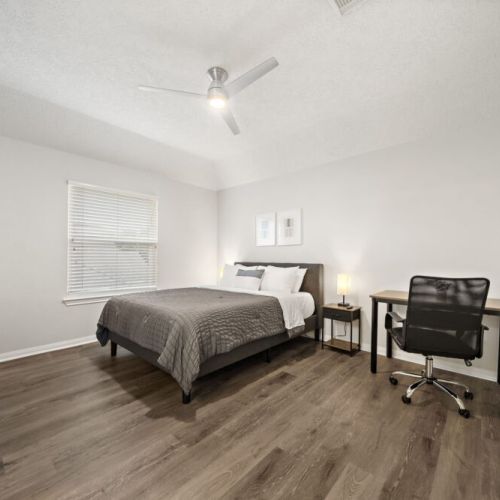 2nd bedroom with a queen-size bed and a dedicated workspace.