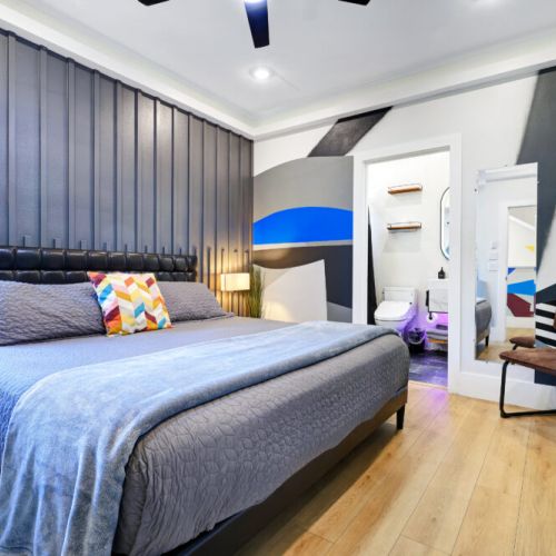 2nd bedroom with king size bed, smart tv, attached bathroom, and electric fireplace