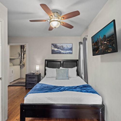 Bedroom with queen size bed! We include a smart TV and a full-length mirror.