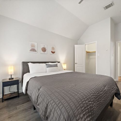 3rd bedroom with a queen-size bed and a dedicated workspace.