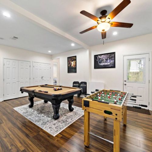 Game room includes full-size pool table, foosball table, and ROKU TV.