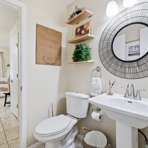 Half bath connected to primary bathroom with additional access from the living room for maximum convenience.