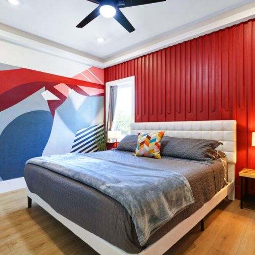 3rd bedroom with king size bed, smart tv, attached bathroom, desk and electric fireplace