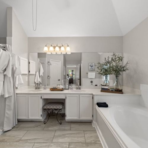 Primary bathroom is fully stocked with all you need. Makeup pads, q-tips, and white robes included.