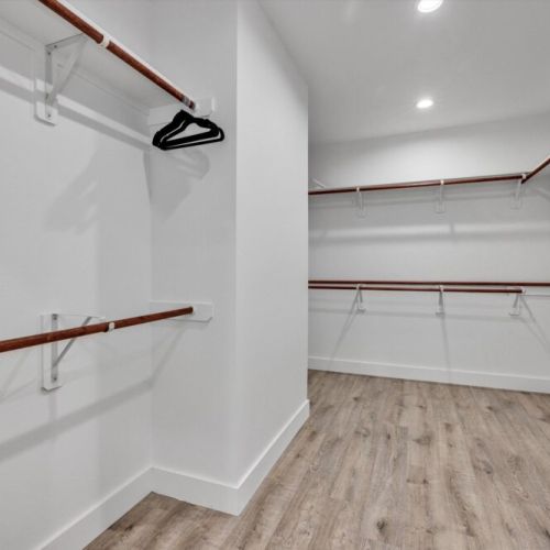 Fully equipped walk-in primary closet.