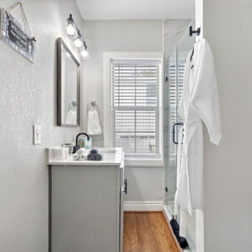 Bathroom  is fully stocked with all you need. Makeup pads, q-tips, and white robes included.