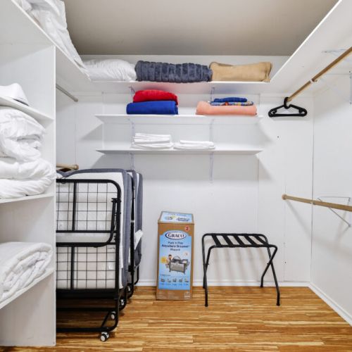 Fully-equipped primary bedroom closet.