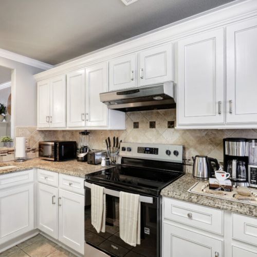 Fully equipped kitchen with high quality granite countertops.