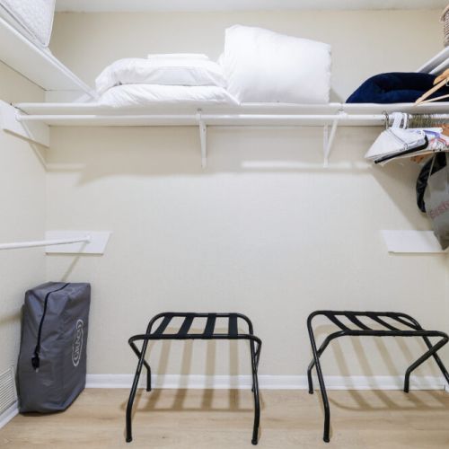Fully-equipped primary bedroom closet. Playpen included for maximum comfort.