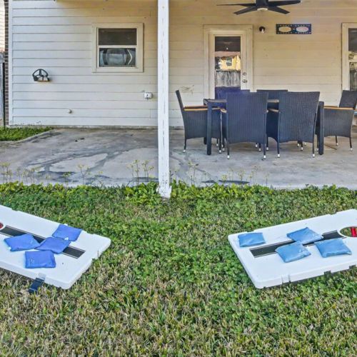 Enjoy a spacious outdoor backyard, perfect for gathering, unwinding, and enjoying outdoor games like a fun, competitive cornhole tournament
