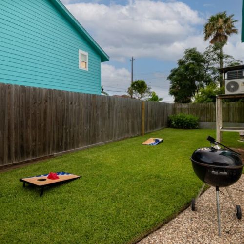Spacious backyard with grill and cornhole set!