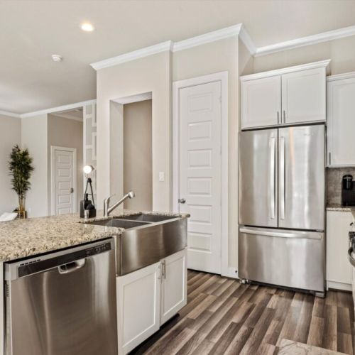 Fridge dispenses water and ice. Stainless steel appliances.