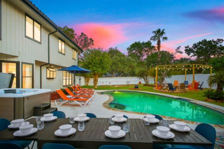 Enjoy an outdoor meal with your group at the table for 10, overlooking the sparkling pool and spacious backyard.