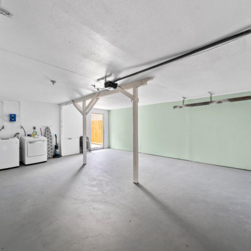 Fully-equipped laundry room in house at the back.