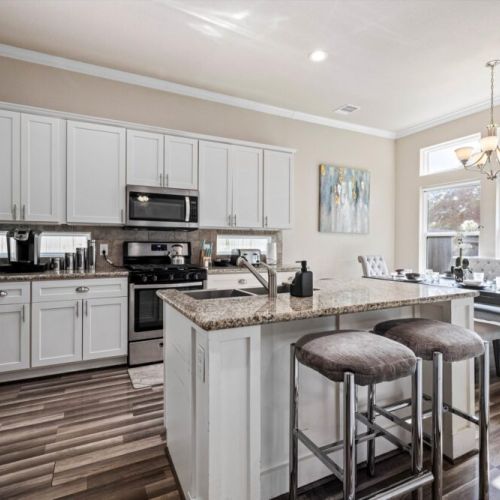 Kitchen island with 2 bar stools for your convenience.