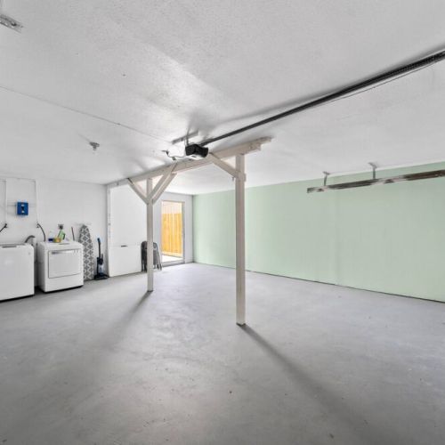 Fully-equipped laundry room in house at the back.