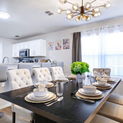 Spacious dining table that sits 8 with full tableware and silverware included.