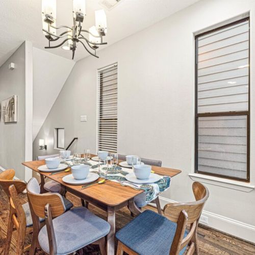 Spacious dining table that sits 6 with full tableware and silverware included.