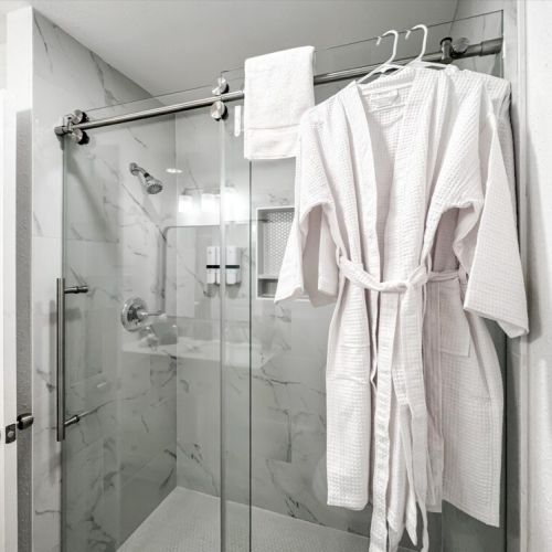 With luxury walk-in shower. White robes included.