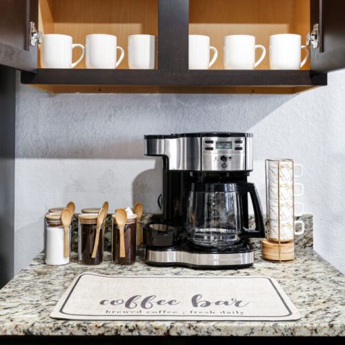2-Way drip coffee machine with complimentary coffee,  decaf, tea, sugar, cream, and sweetener.