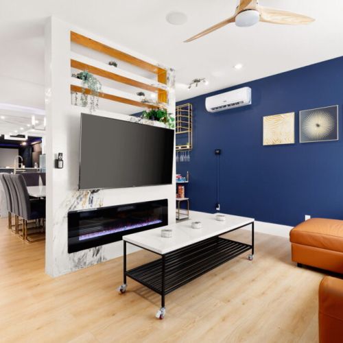 A cozy living room where the warmth of the fireplace meets the comfort of a spacious sofa