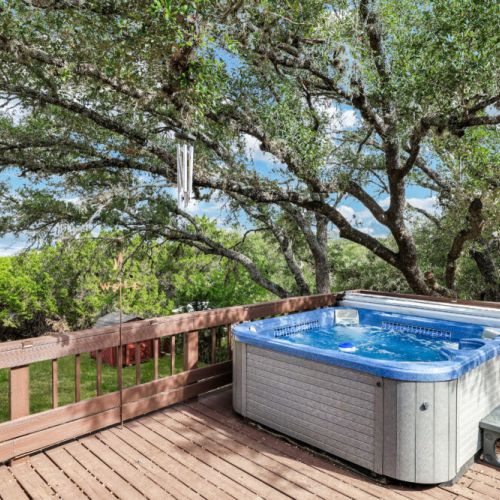 Unwind in the luxurious hot tub surrounded by stunning hill country views—a perfect spot to share laughter and sunsets.