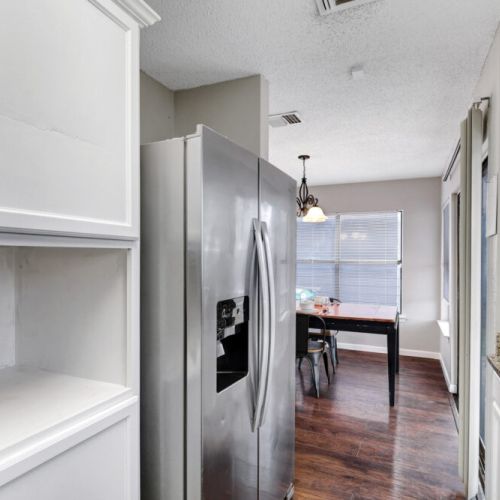 Fridge dispenses water and ice. Stainless steel appliances.