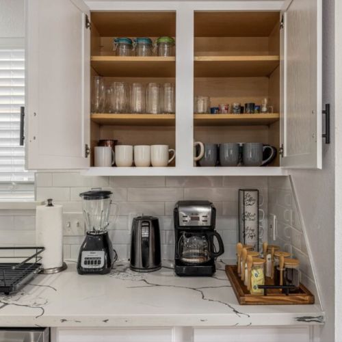 Drip coffee machine with complimentary coffee, decaf, tea, sugar, cream, and sweetener.