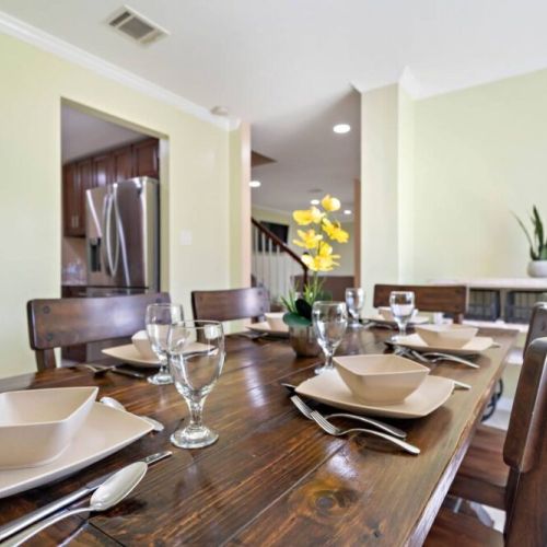 Spacious dining table that sits 6 with full tableware and silverware included.
